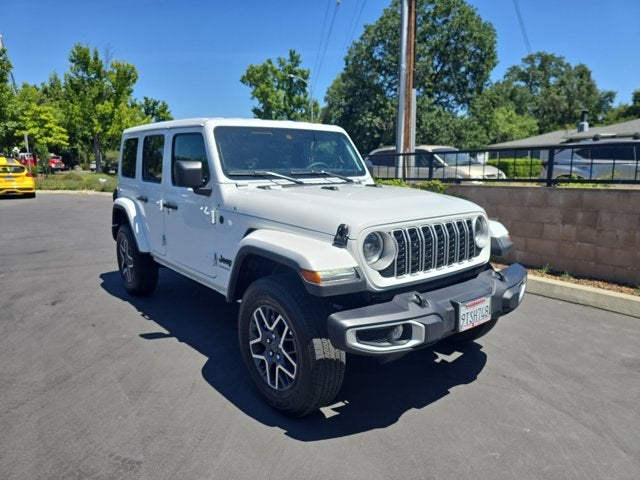 2025 Jeep Wrangler 4-Door Sahara 4x4 in Bright White Clearcoat — front three-quarter view
