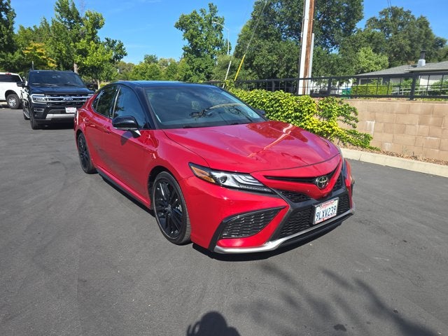 2024 Toyota Camry XSE V6 in Supersonic Red — front three-quarter view